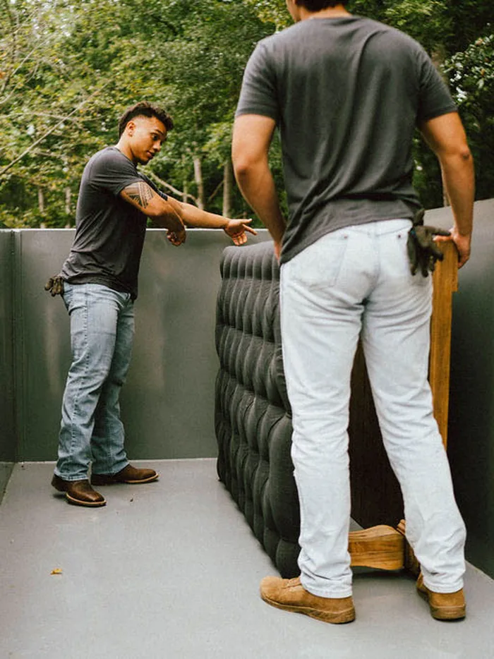 Furniture Disposal Plus Loaders loading furniture into the truck and trailer for haul-away